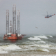 Helicopter and oil rig in storm at sea