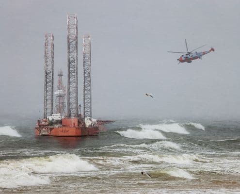 Helicopter and oil rig in storm at sea